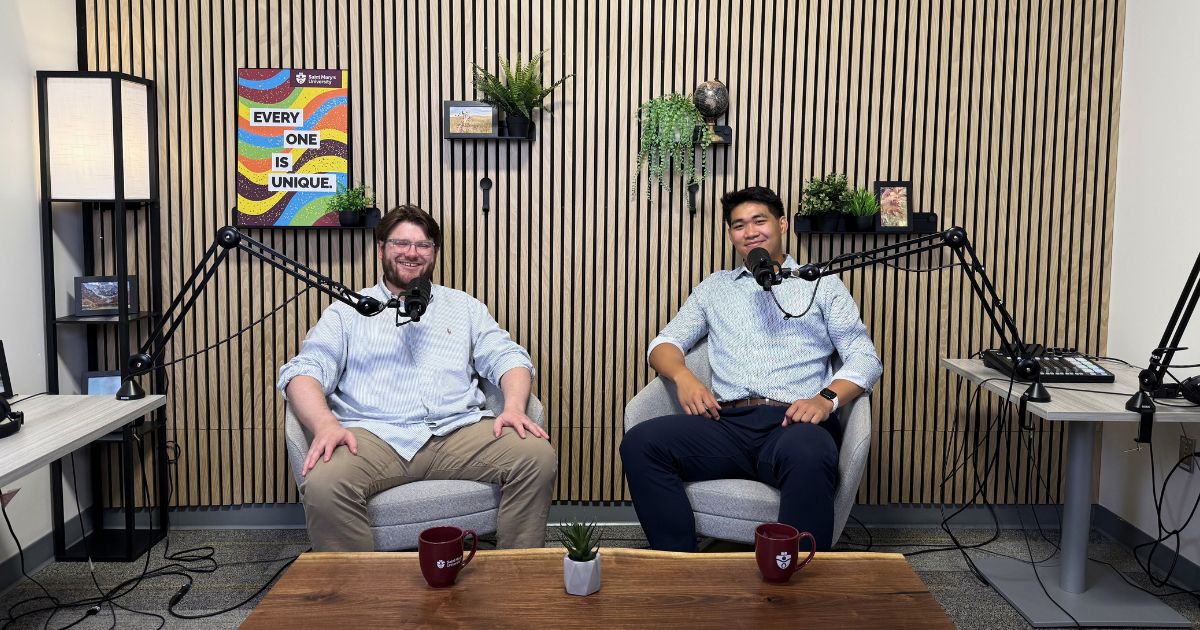 A professor and student sit together in the podcast studio