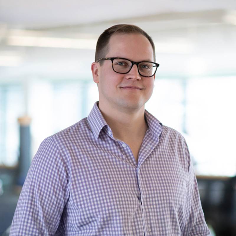 John Fiset smiling in a professional setting