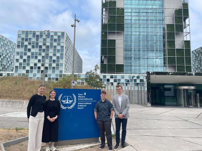 4 SMU POLI students in front of the sign of the ICC
