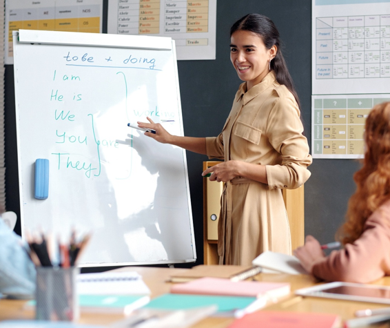 A woman giving a presentation using a whiteboard