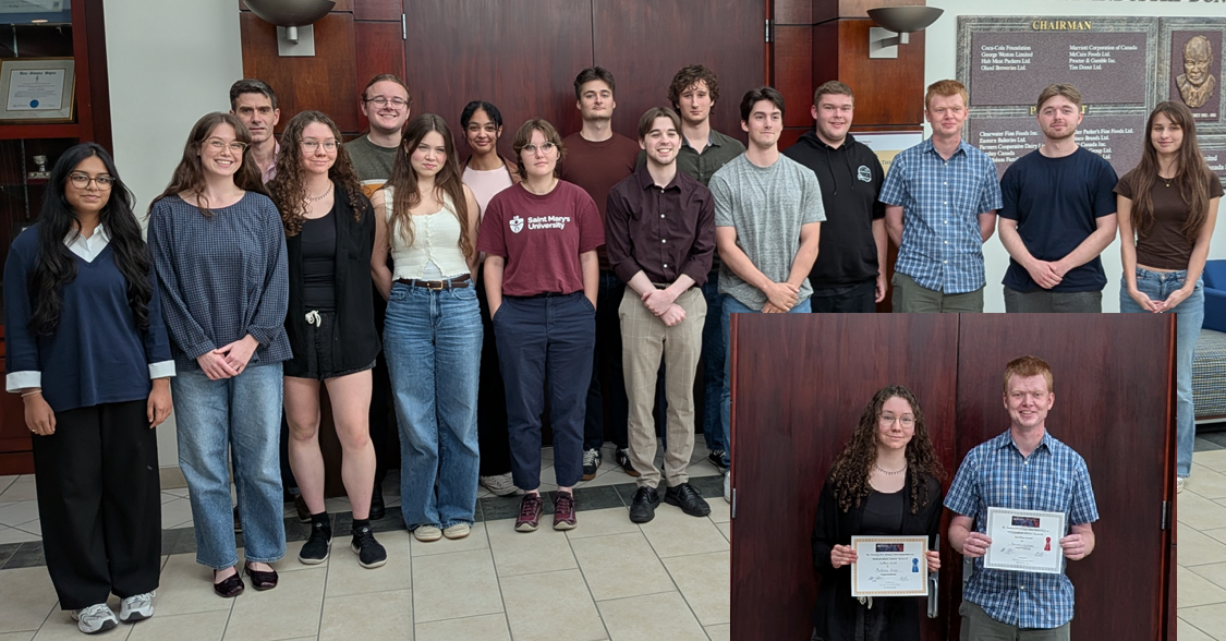 15 students and 1 instructor standing in front of double doors